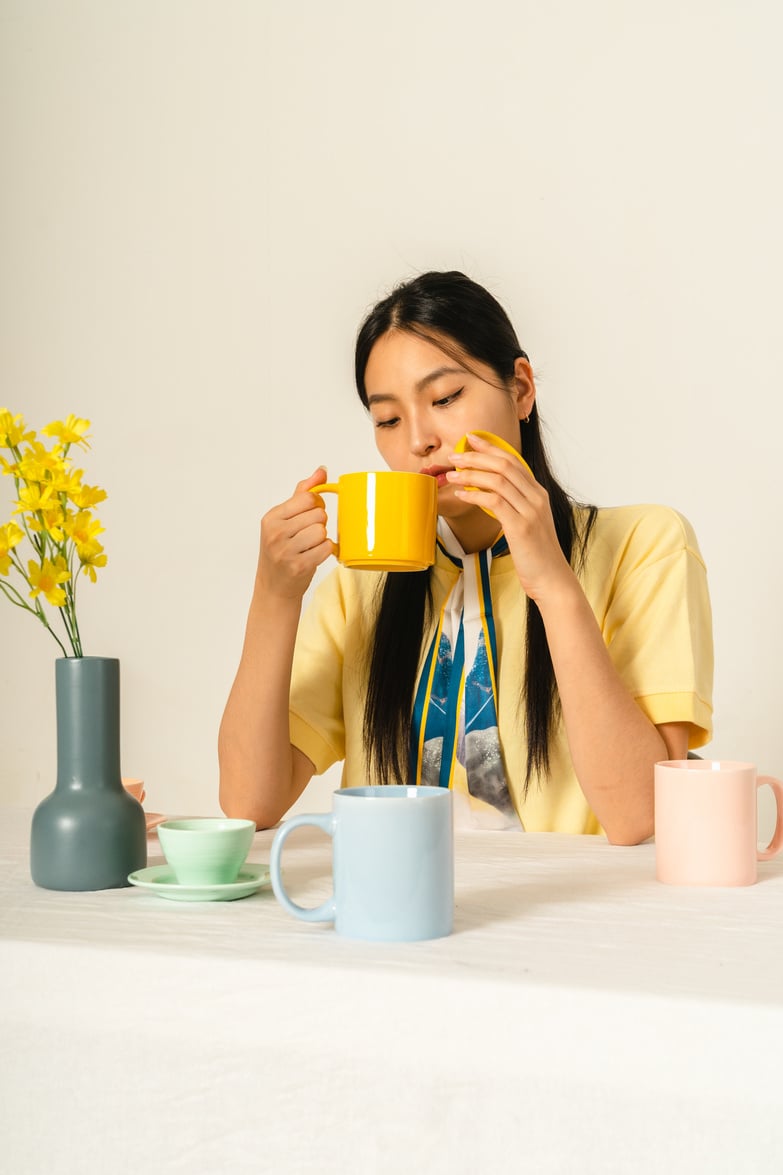 Woman with Ceramic Mugs